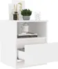 A white bedside table with items on and inside it. Voir les images du produit
