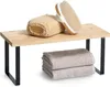 A bamboo shelf with black metal legs, displaying bath accessories and towels. Produktbild-Vorschau