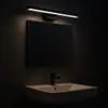 A bathroom vanity with a sink, faucet, and a mirror illuminated by an LED light fixture. Náhled obrázku produktu