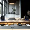 A modern office desk with two compact stereo speakers, a laptop, a coffee cup, and other office supplies. Náhľad obrázku produktu
