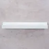A white shelf mounted on a gray concrete wall. Produktbild-Vorschau