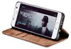 A smartphone in a brown flip case is displayed on a white background, showing a movie poster on its screen. Produktbild-Vorschau