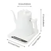 A white electric kettle with a gooseneck spout sits on its charging base, with dimensions indicated by measurement lines and text. Náhled obrázku produktu