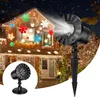 A house decorated with Christmas lights and snowflake projections, with a snowflake projector in the foreground. Produktbild-Vorschau