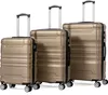 Three gold suitcases of different sizes are displayed side-by-side against a white background. Náhľad obrázku produktu