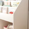 A close-up view of a white bookshelf filled with children's books. Podgląd zdjęcia produktu