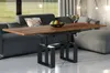 A modern living room with a sofa, coffee table, and ottoman. Voir les images du produit