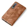 A brown leather flip case for a smartphone is shown against a white background. Produktbild-Vorschau