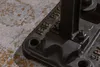 A close-up of the base of a table, showing metalwork and some text. Produktbild-Vorschau