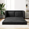 A black sofa bed is displayed in a brightly lit room with a large plant and a bookshelf. Anteprima dell’immagine prodotto