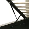 A close-up view of the internal mechanism of a bed frame, showing a hydraulic lift system and wooden slats. Produktbild-Vorschau