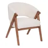 A white, fluffy armchair with wooden legs, presented against a white background. Podgląd zdjęcia produktu