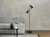 A modern living room scene with a sofa, a floor lamp, and decorative items on a coffee table. Produktbild-Vorschau