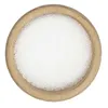 A top-down view of citric acid in a wooden bowl. Produktbild-Vorschau