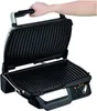 A hand is shown opening a black electric grill. Produktbild-Vorschau
