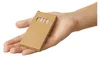 A hand holding a small cardboard box containing colored pencils. Produktbild-Vorschau