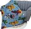 A blanket with a Lego Ninjago pattern is draped over a chair. Anteprima dell’immagine prodotto