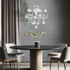 A dining room scene with a round table, chairs, and a chandelier. Anteprima dell’immagine prodotto