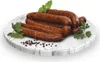 Sausages on a marble plate with herbs and peppercorns. Náhled obrázku produktu