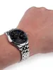 A person's wrist wearing a watch. Podgląd zdjęcia produktu