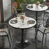An outdoor cafe setting with tables and chairs in the rain. Anteprima dell’immagine prodotto
