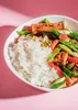 A bowl of food with rice and vegetables. Produktbild-Vorschau