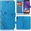 A collage of images showing a blue flip phone case with a floral and butterfly design, including shots of the case open with cards and money inserted, and the back of the case. Produktbild-Vorschau