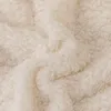 A close-up view of a fluffy, cream-colored fabric, likely a blanket or throw. Podgląd zdjęcia produktu