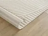 A close-up view of a rolled-up rug on a wooden floor. Produktbild-Vorschau