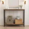 A console table with storage baskets and boxes on a shelf, against a white paneled wall. Produktbild-Vorschau