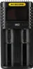 A black Nitecore battery charger is shown against a black background. Podgląd zdjęcia produktu