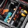 A close-up view inside a black tool case, showing various tools and safety equipment. Náhled obrázku produktu