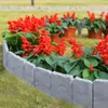 A garden bed with red flowers bordered by gray stone-effect edging. Náhled obrázku produktu