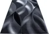 A rectangular rug with a modern abstract design in shades of gray and black, presented on a white background. Podgląd zdjęcia produktu