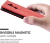A hand holding a red phone case, showcasing its magnetic closure feature. Náhled obrázku produktu