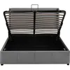 A grey upholstered bed frame with the mattress support mechanism lifted, revealing the storage space underneath. Produktbild-Vorschau