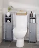 A bathroom scene with a toilet and two narrow storage cabinets on either side. Podgląd zdjęcia produktu