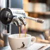 Espresso being brewed into a white cup with a logo. Produktbild-Vorschau