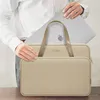 A person is holding a laptop bag with a laptop inside. Náhľad obrázku produktu