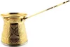 A golden coffee pot with intricate carvings and a long handle, isolated on a white background. Produktbild-Vorschau