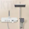 A modern shower system with a rain shower head, hand shower, and a control panel with a glass shelf. Náhled obrázku produktu