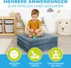 A young boy is playing with building blocks on a folded mattress in a child's room. The image includes marketing icons and text. Produktbild-Vorschau