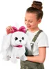 A young girl is holding a white toy puppy with a pink bow and collar. Náhled obrázku produktu