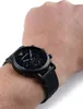 A close-up shot of a black Emporio Armani watch on a person's wrist. Produktbild-Vorschau
