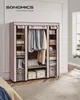 A pink fabric wardrobe with clothes hanging inside and shelves filled with folded clothes and storage boxes. Náhled obrázku produktu
