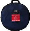 A round, dark blue duffel bag with a mesh exterior and various labels attached. Voir les images du produit