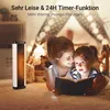A mother and daughter are reading a book by the light of a flashlight and a heater. Produktbild-Vorschau
