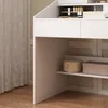 A close-up view of a white vanity table with drawers and shelves, showing some makeup items and storage boxes. Produktbild-Vorschau