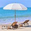 A beach scene with a white umbrella and two lounge chairs. Produktbild-Vorschau