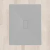 A flat gray shower tray with a rectangular drain opening in the center, placed on a light wood-plank floor. Produktbild-Vorschau